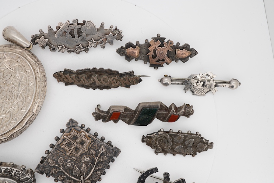 Ten assorted late 19th/early 20th century silver brooches, including three with names, Baby, Millicent and Ellen, together with five other white metal brooches including Scottish hardstones, a coin set stick pin, hardsto